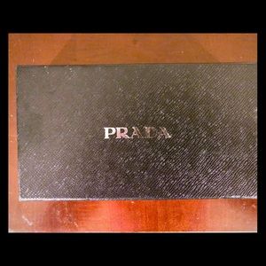 Prada boxes with tissue paper and ribbons.